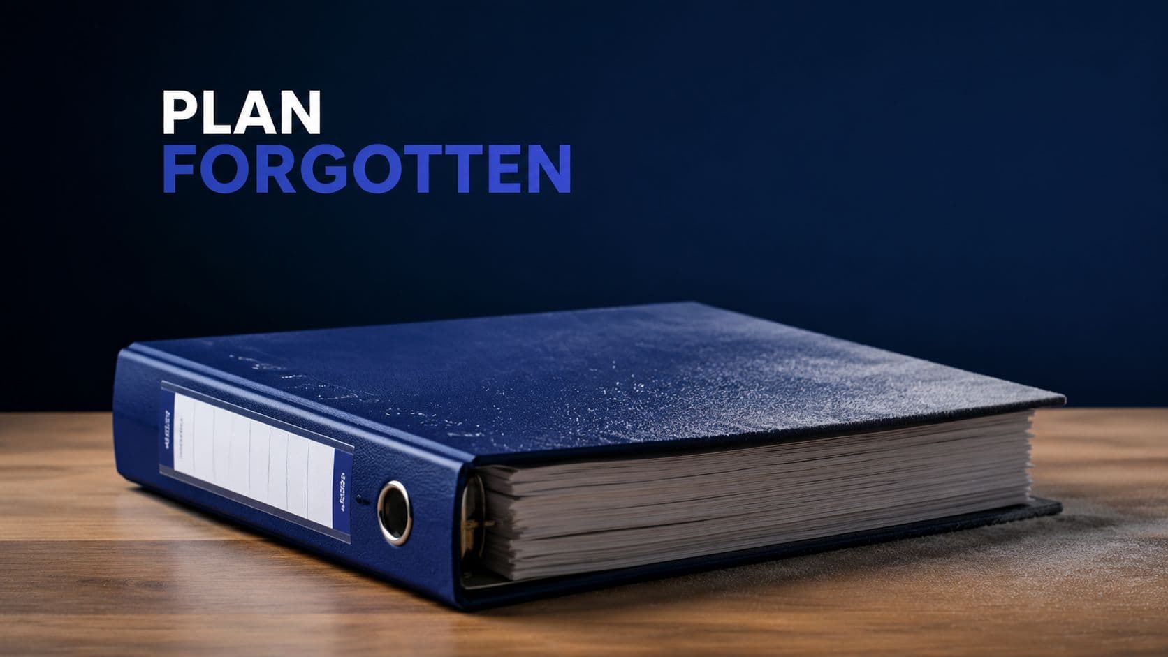 A dusty blue ring binder sitting on a wooden desk, symbolizing a forgotten enterprise sales plan.