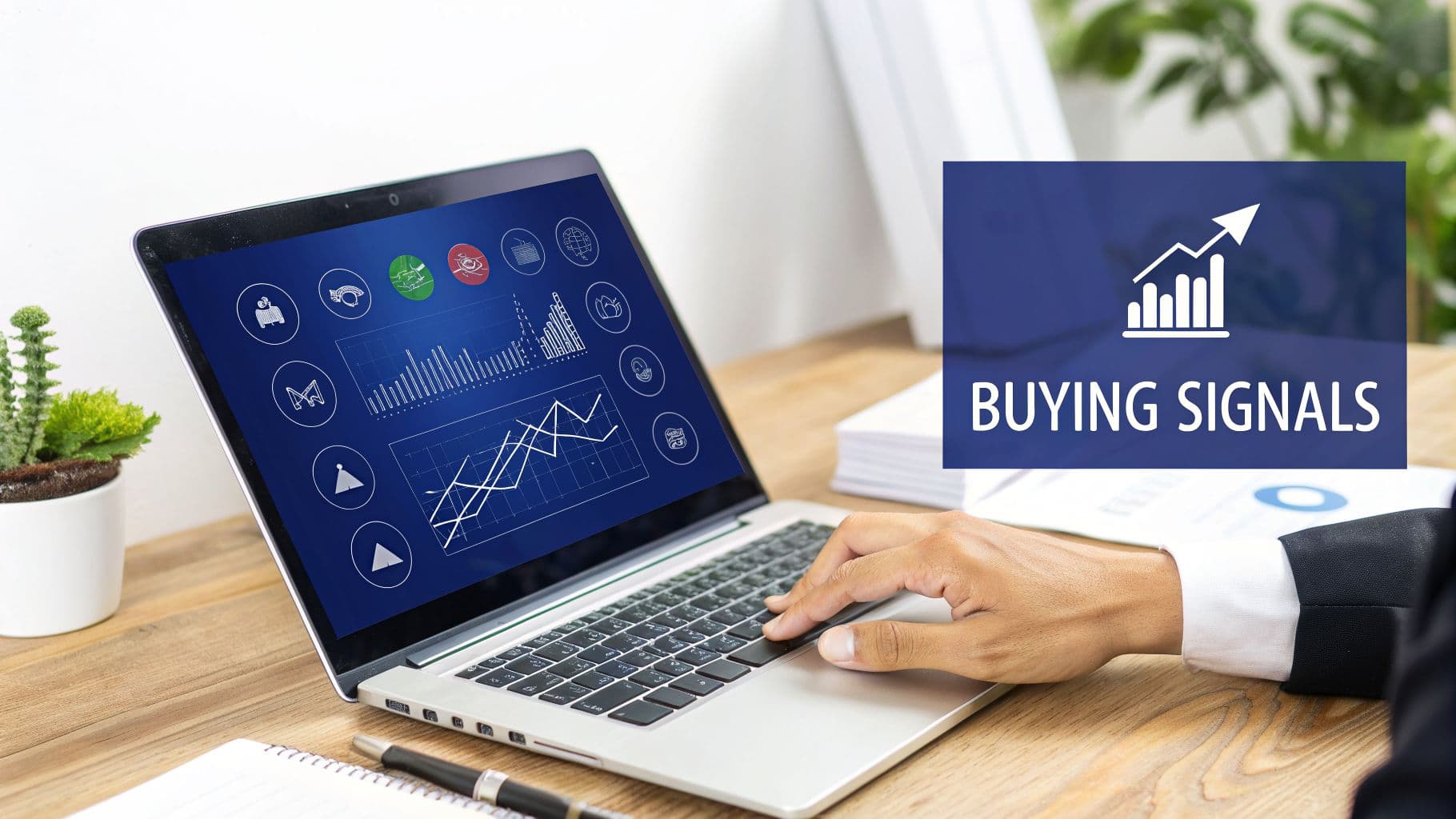 A person using a laptop displaying financial charts and a prominent 'Buying Signals' overlay.