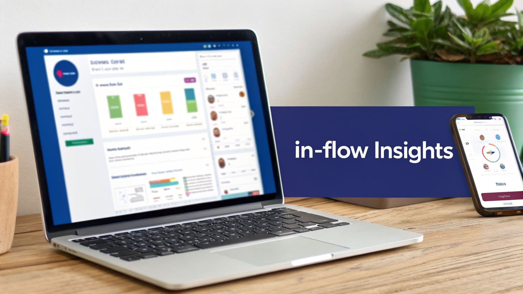 Laptop and smartphone on a wooden desk displaying digital insights and business data dashboards.