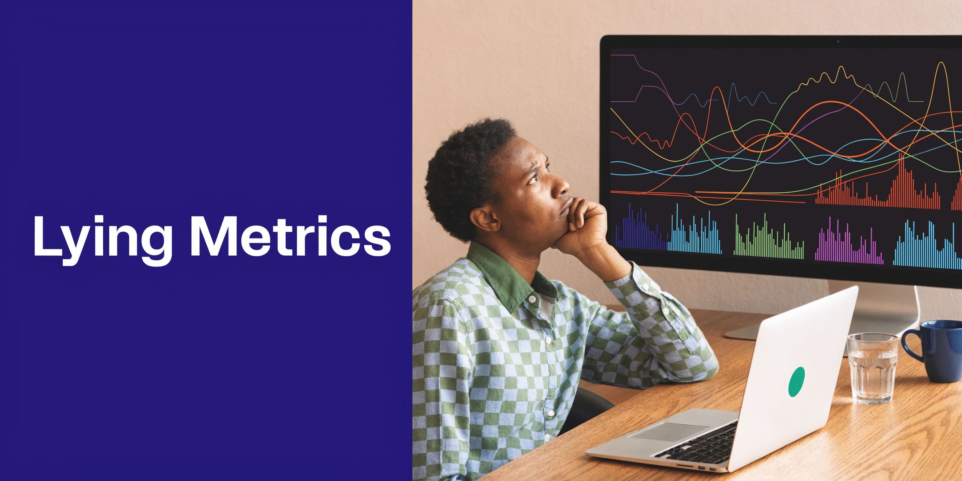 A thoughtful young professional looks at complex data charts on a computer monitor in an office.